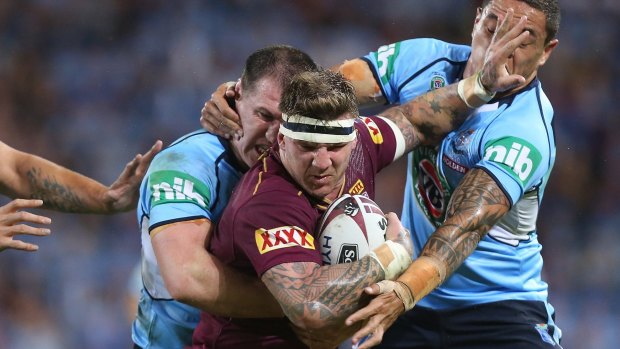 Josh McGuire of the Maroons is tackled by Paul Gallen and Tyson Frizell during State of Origin game II.