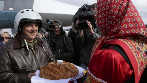 A Russian pilot who returned from Syria is welcomed with traditional bread and salt at an airbase near Voronezh.