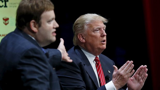 Donald Trump  responds to a question from Frank Luntz (left) at the event in Iowa.