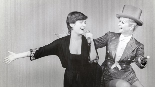 Carrie Fisher, left, and her mother Debbie Reynolds perform together in archival footage from the  documentary, <i>Bright Lights</i>. 