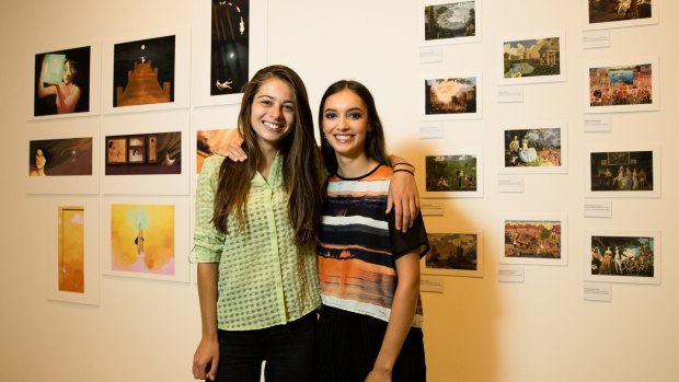 Emmanuelle Mattana (left) and Ellora Srivastava, with Ellora's work, 'Karmic Colonialism' in the ARTEXPRESS exhibition at the Art Gallery of NSW in Sydney.