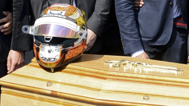 The helmet of late Marussia Formula One driver Jules Bianchi is placed on his coffin.