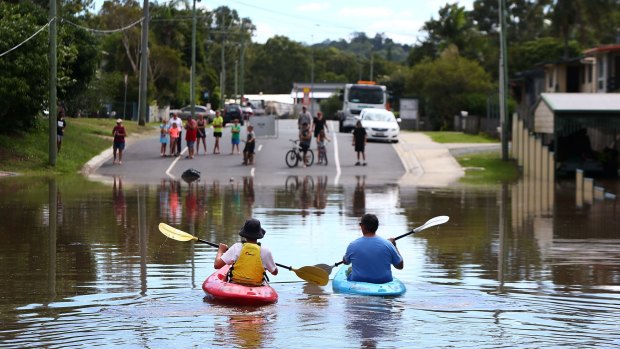 Michael and Caleb Eadie made the most of the flooding at Kokoda Street, Beenleigh.