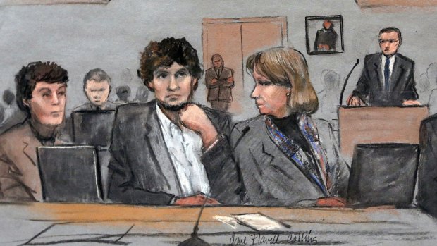 In this courtroom sketch, Dzhokhar Tsarnaev  is depicted between his defence attorneys.