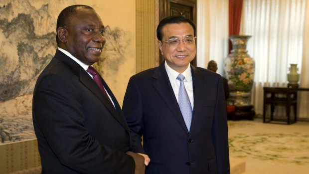 South Africa Deputy President Cyril Ramaphosa shakes hands with Chinese Premier Li Keqiang in Beijing on Tuesday. 