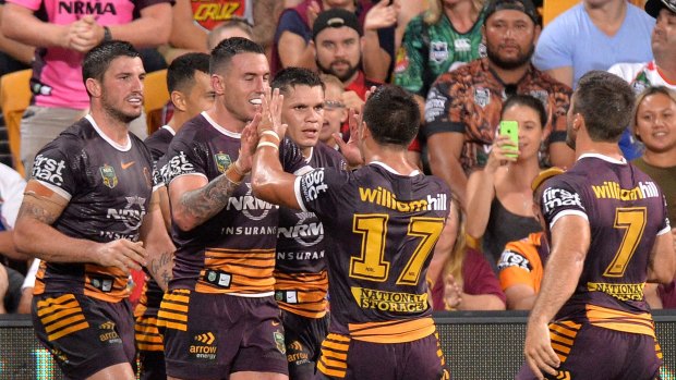 Boyd done good: Darius Boyd takes the congratulations of his Broncos teammates after scoring a try.