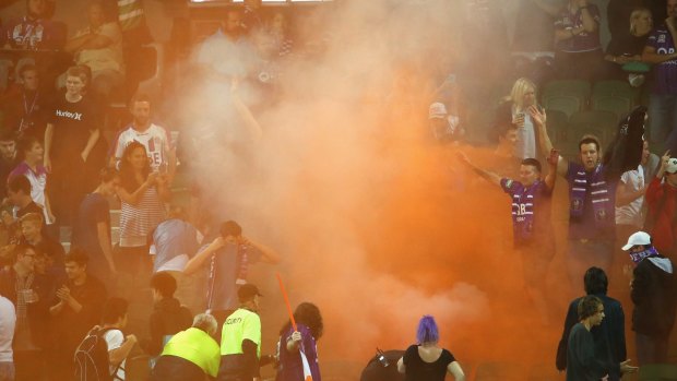 Fired up: Perth Glory fans let off a flare during their 3-0 home loss to Sydney FC.