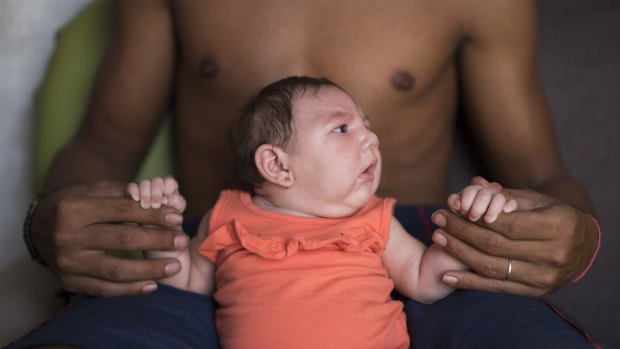 Dejailson Arruda holds his daughter Luiza at their house in Santa Cruz do Capibaribe, Pernambuco state, Brazil. Luiza was born in October with microcephaly, her mother was infected with the Zika virus.