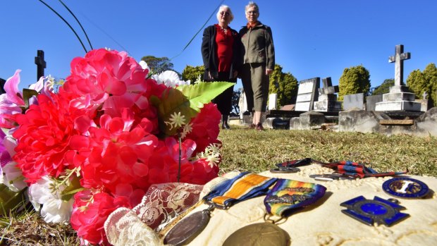 Jennifer Furness and Lyndell Ford (right) placed Nurse Cashin's medals on her unmarked grave.