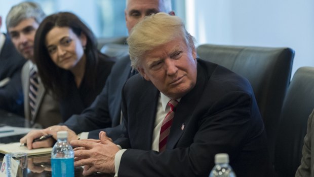 Donald Trump with (from left) Larry Page, Sherryl Sandberg and Mike Pence, listens in the direction of Tim Cook at the meeting on Wednesday.