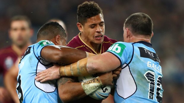 Overcame the odds: Dane Gagai is wrapped up during Origin I at ANZ Stadium.
