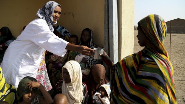 Mothers feed their babies moderate acute malnutrition (MAM) food at a health post in Dubti, Ethiopia's Afar region. 