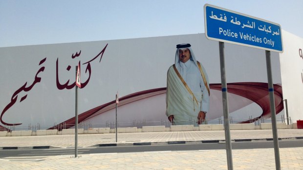 An image of Qatar's emir, Sheikh Tamim bin Hamad Al Thani, graces a billboard featuring the slogan "We are all Tamim" in Doha, Qatar, on Monday.