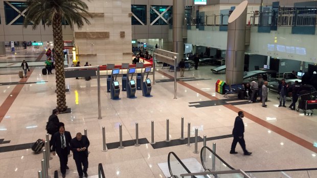 Airport staff gather near a security checkpoint at Cairo International Airport.