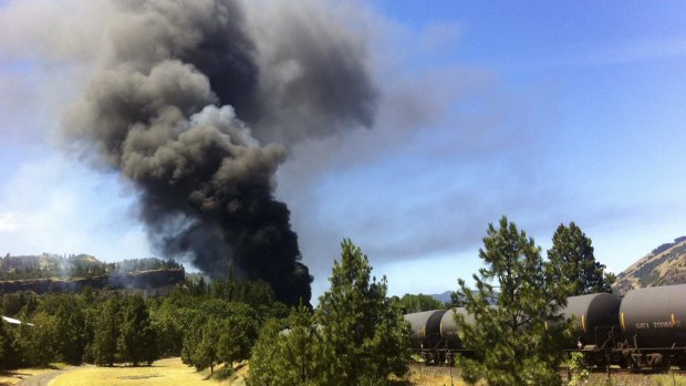 A train towing cars full of oil sends up a plume of smoke after derailing by the scenic Columbia River Gorge, Oregon. 