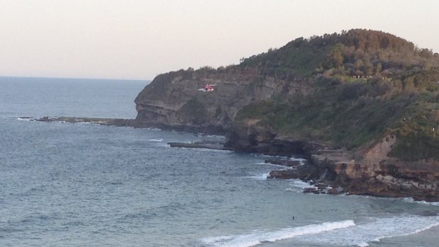 Cliff fall: a rescue helicopter arrives at Warriewood Beach. 