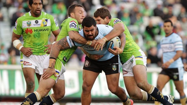 In strife: David Fifita is brought down by the Raiders.