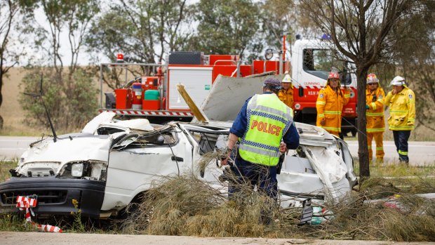 Emergency services personnel attend a crash scene on the Hume highway near Oolong where a female driver of a van died on Thursday morning after accidentally clipping a truck. 