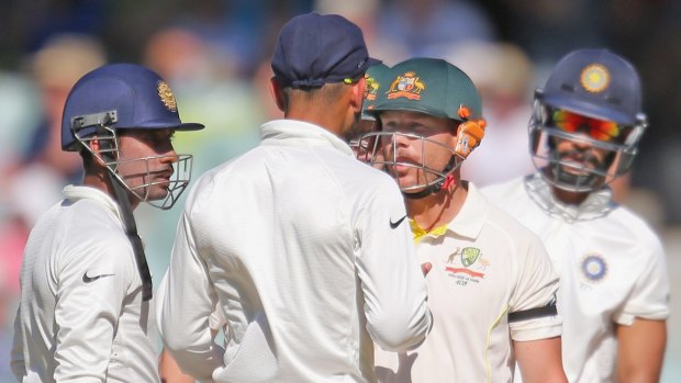 Verbal: David Warner and Virat Kohli face up words after the Australian exchanged words with Varun Aaron after being called back while on his way to the pavilion.