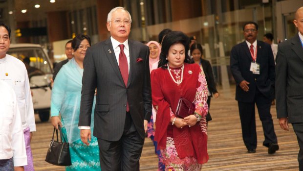 Malaysia's Prime Minister Najib Razak walks with his wife, Rosmah Mansor. 