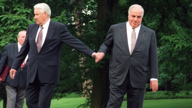 German Chancellor Helmut Kohl, right, guiding Russian President Boris Yeltsin through the park after Yeltsin's arrival for talks at the Bonn Chancellery, 1998.