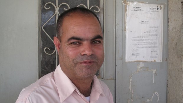Khalil al-Amour with a notice of eviction pinned to the front door of his home in the Negev Desert village of al-Sira in 2011.  