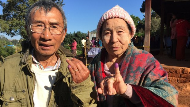 Voters in Kalaw, Myanmar, display their inked fingers after voting in the national election. 