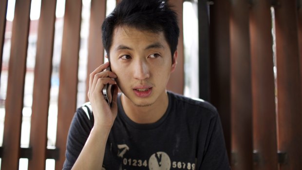 Hong Kong photojournalist Hok Chun Anthony Kwan with dual Hong Kong-Canadian citizenship speaks on the phone in Thailand in August after he was released on bail. 
