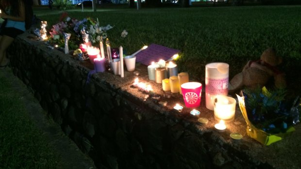 Candles lit in tribute to eight children who were killed at a home in Cairns.