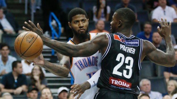 Far from overawed: Oklahoma City Thunder forward Paul George has to pass around Melbourne United forward Casey Prather.