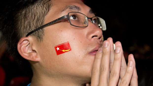 A supporters of Myanmar's National League for Democracy party watching early voting results outside the NLD headquarters in Yangon on Sunday. 