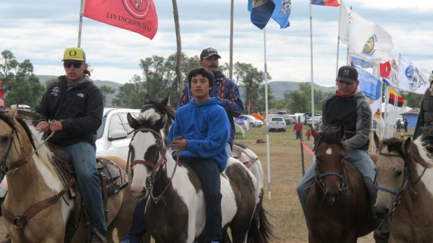 Fears development will disturb sacred land: Horseback riders make their way through an encampment near North Dakota's Standing Rock Sioux reservation.