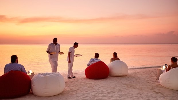 Sunset drinks on the beach at LUX North Male Atoll resort in the Maldives.