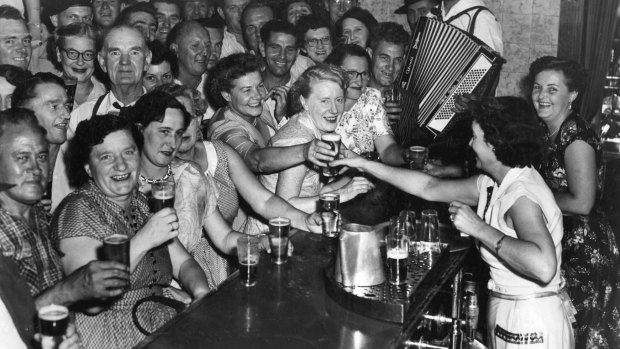 Patrons enjoy a beer at a Sydney pub in 1955. 
