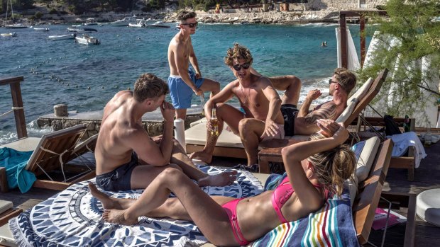 A group of tourists at the popular Hula Hula beach bar on Hvar, Croatia.