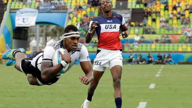 Power and grace: Fiji's Semi Kunatani scores against the US.