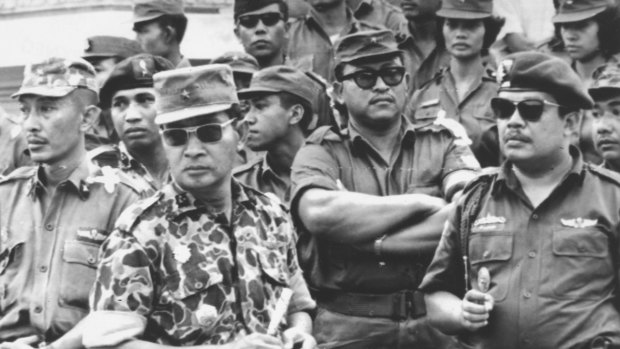 Indonesia's Major-General Suharto, in camouflage uniform, at the funeral for six generals killed by rebels in the abortive attempt to overthrow then president Sukarno in 1965. The coup attempt led to nationwide massacres. 