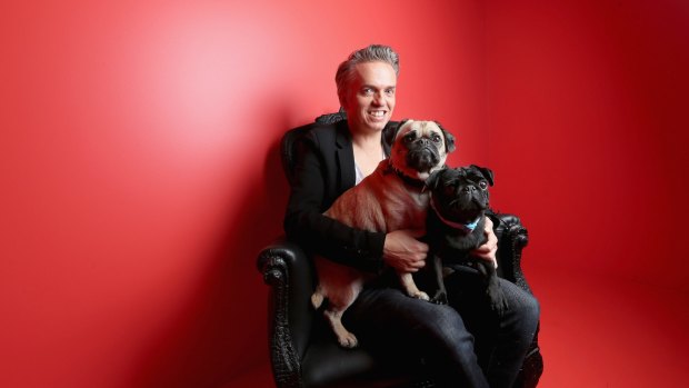 Puppy love: Craig Braybrook poses for a photo with his pugs Lola (cream) and Wilbur (black).
