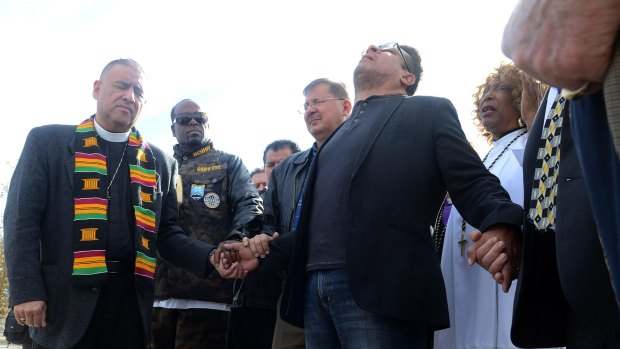 A group of pastors from area churches hold a prayer vigil in San Bernardino on Thursday.