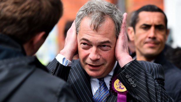 UKIP leader Nigel Farage covers his ears as he campaigns in Ramsgate in south east England on on Wednesday.