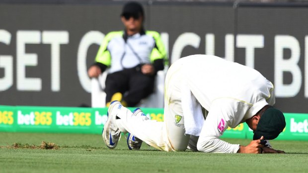 Make your mark: Usman Khawaja dug his knee into the turf in an attempted slide.
