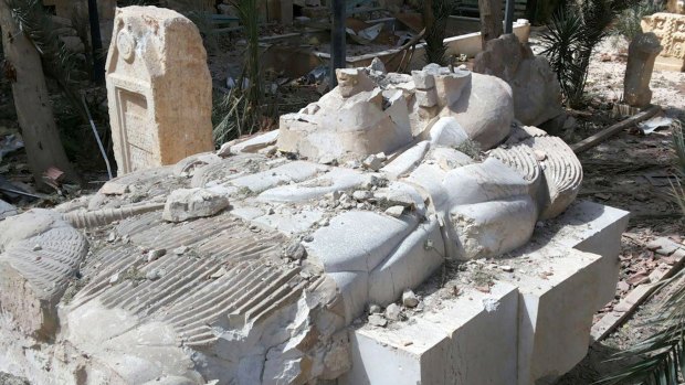 The destroyed Lion of al-Lat statue outside the damaged Palmyra Museum in December.