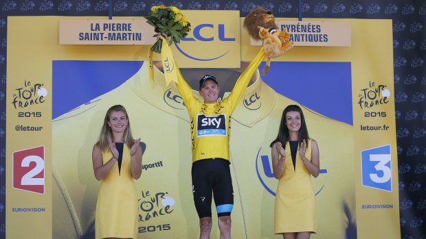 Stage winner Britain's Christopher Froome, wearing the overall leader's yellow jersey, celebrates on the podium of the tenth stage of the Tour in La Pierre-Saint-Martin.