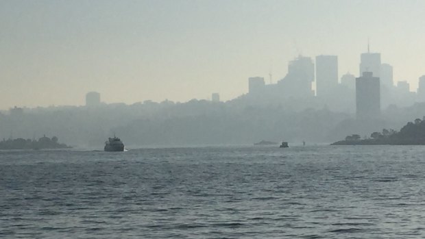 Haze hangs over the harbour because of controlled burns in Sydney's west, north and south. More is planned for this weekend. 
