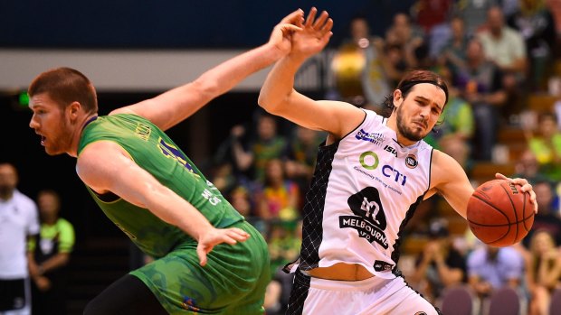 Chris Goulding of Melbourne United deceives Brian Conklin of Townsville and sends him the wrong way.