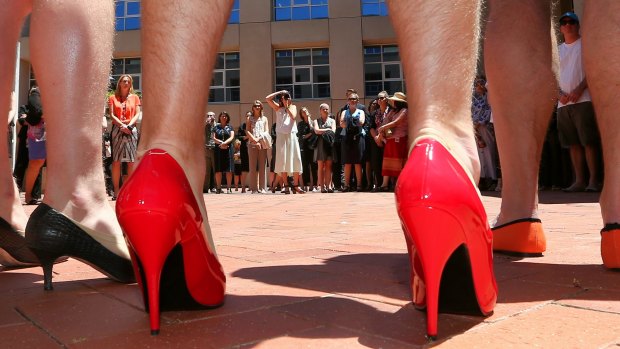Male public servants in women's shoes during a walk to Parliament House in 2015. 