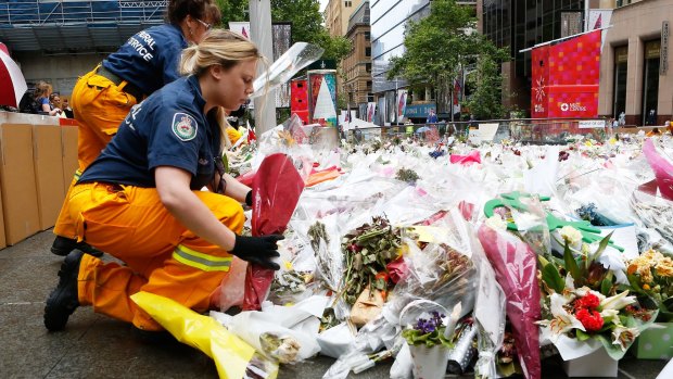 Volunteers remove flowers from Martin Place.