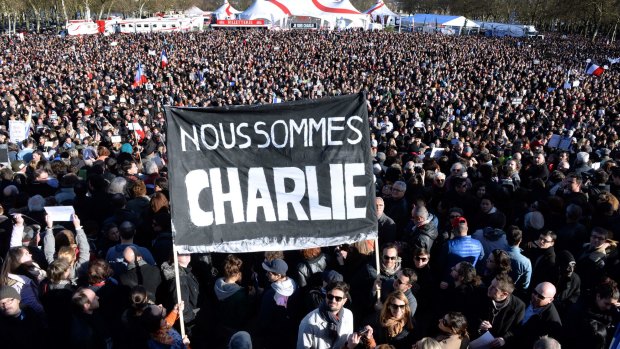 People hold a banner reading in French "We are Charlie" during a march in Bordeaux. 