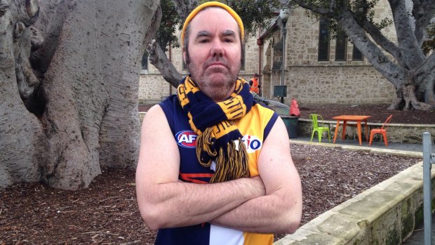 Blue-and-gold steel: Brendan Foster proudly sports Eagles colours deep in Freo territory.