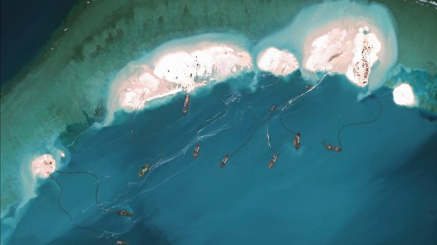 A satellite image shows dredgers working at the northernmost reclamation site of Mischief Reef, part of the Spratly Islands, in the South China Sea in March 2015. 